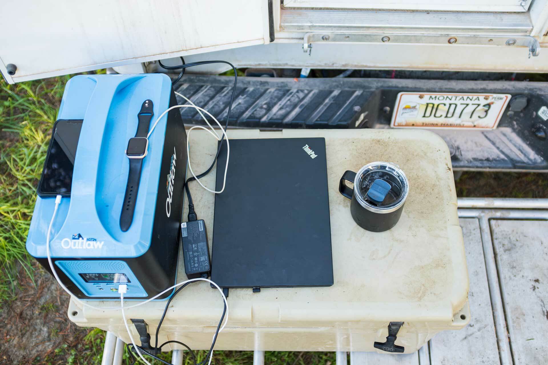 camping power station charging a laptop and smart devices