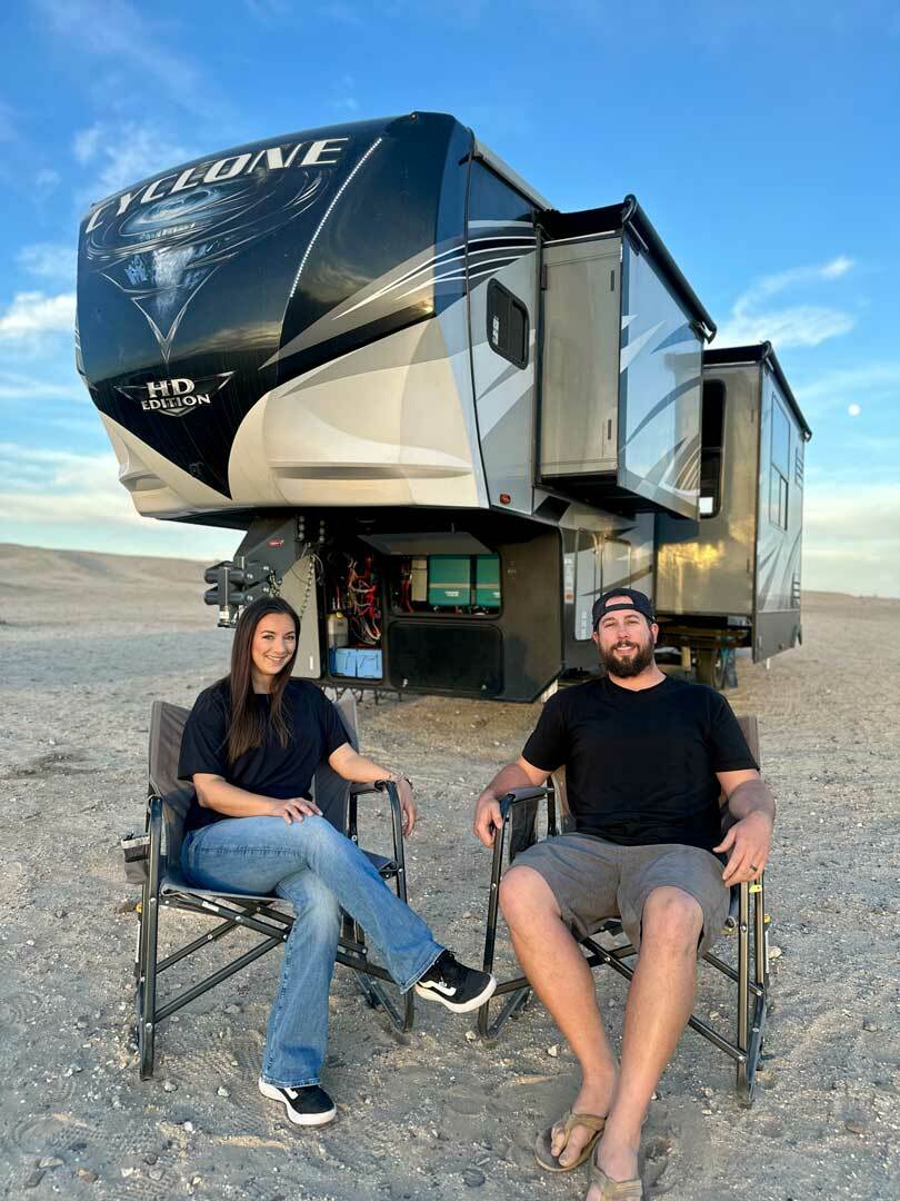 Tyler and Alexis Winn sitting in front of their RV